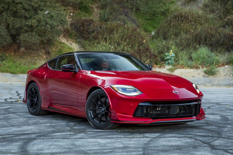 A red Nissan Z is standing on the road with rubber marks