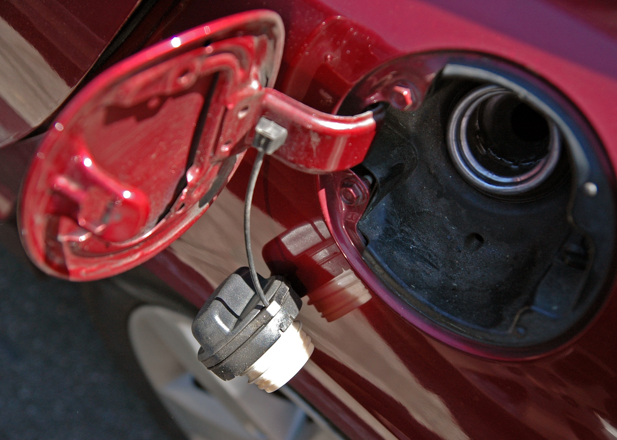 Open fuel door of a red car