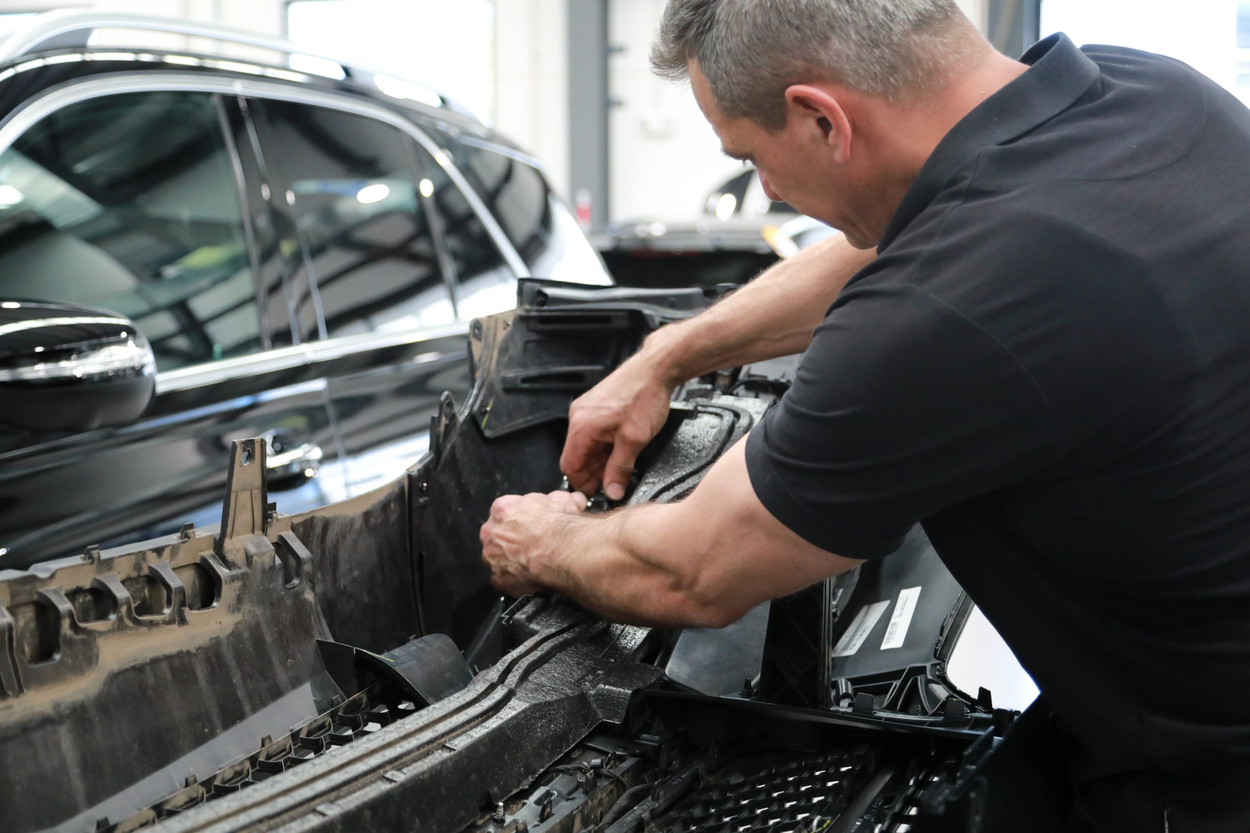 Parramatta Smash Repairs Technician working on the engine bay