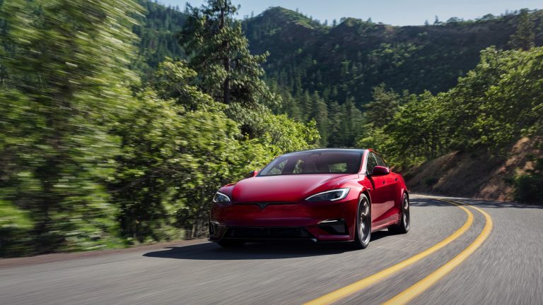 A red Tesla Model S cruising on the highways at high speed