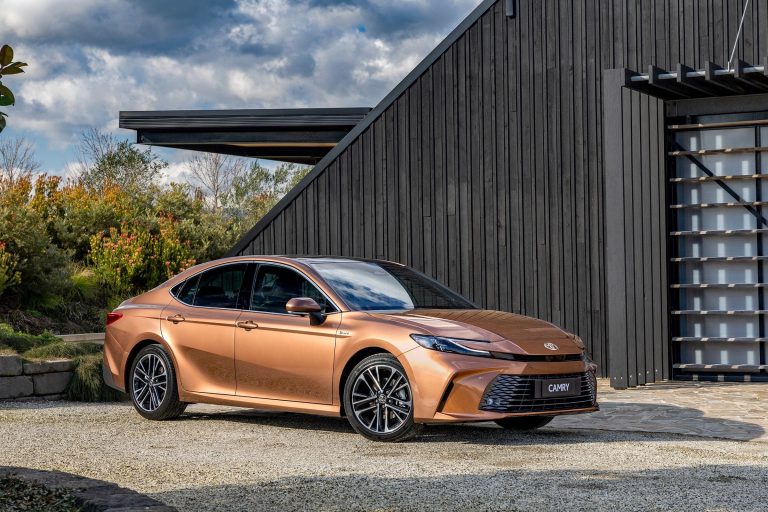 A Toyota Camry is standing in front of a shack