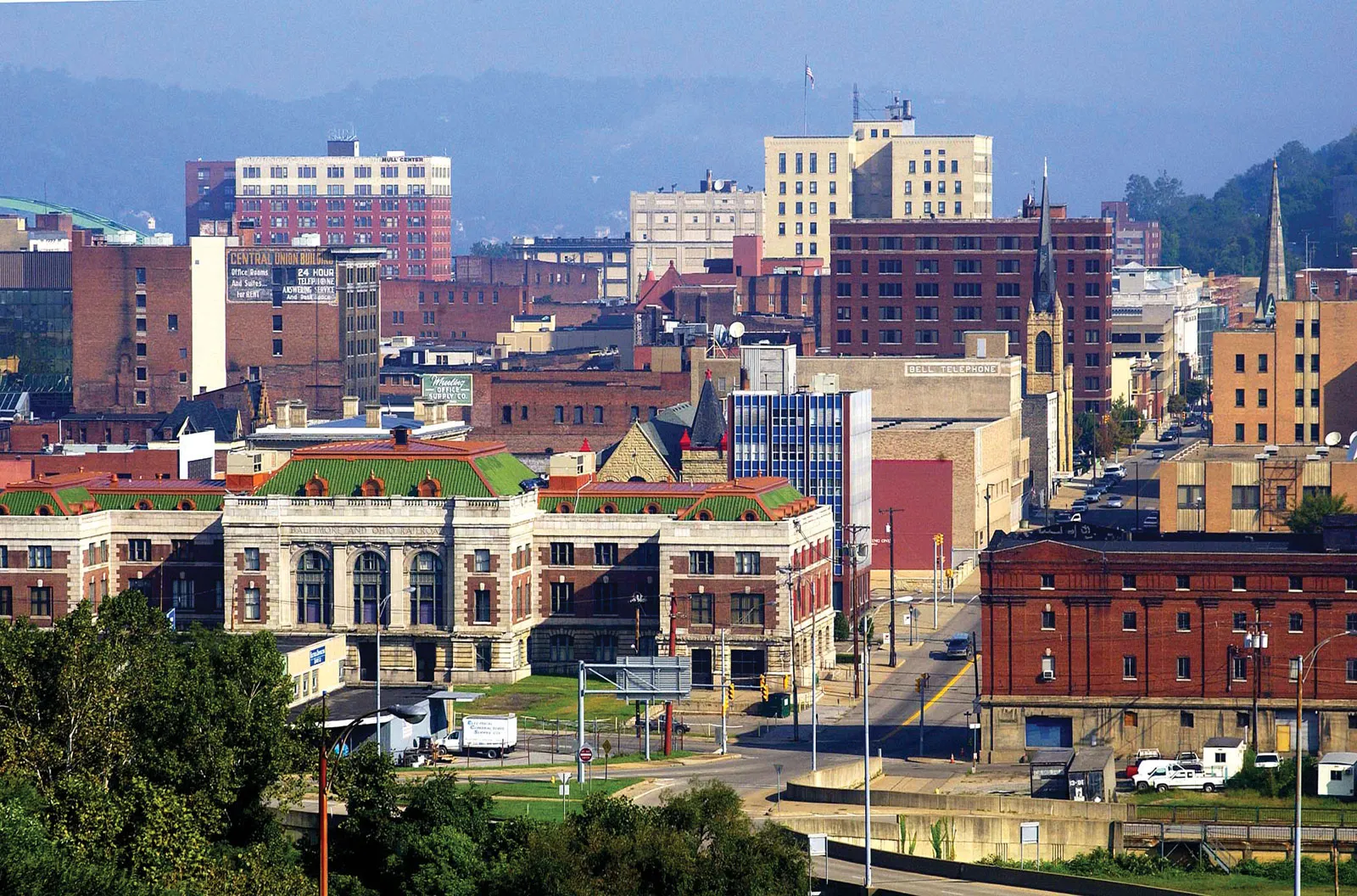 A dense cityscape featuring varied brick and historic buildings