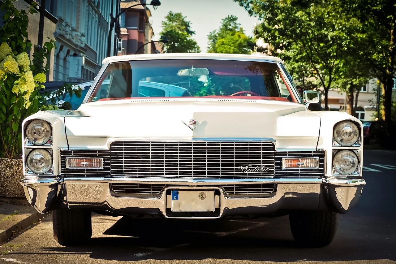 A vintage car is standing on a street road