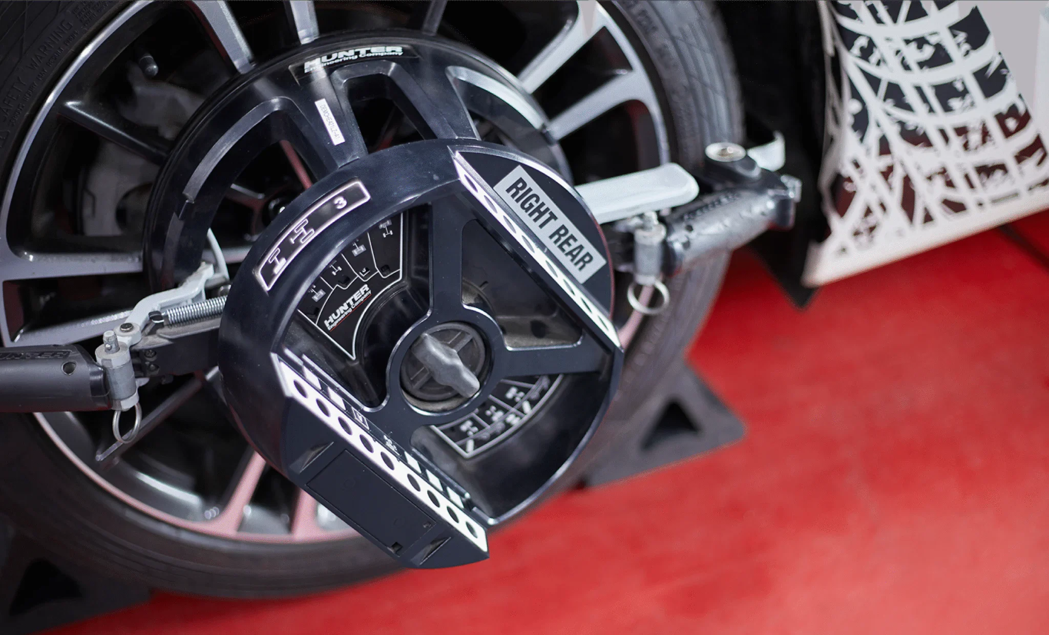A Wheel Alignment equipment is attached to a tire