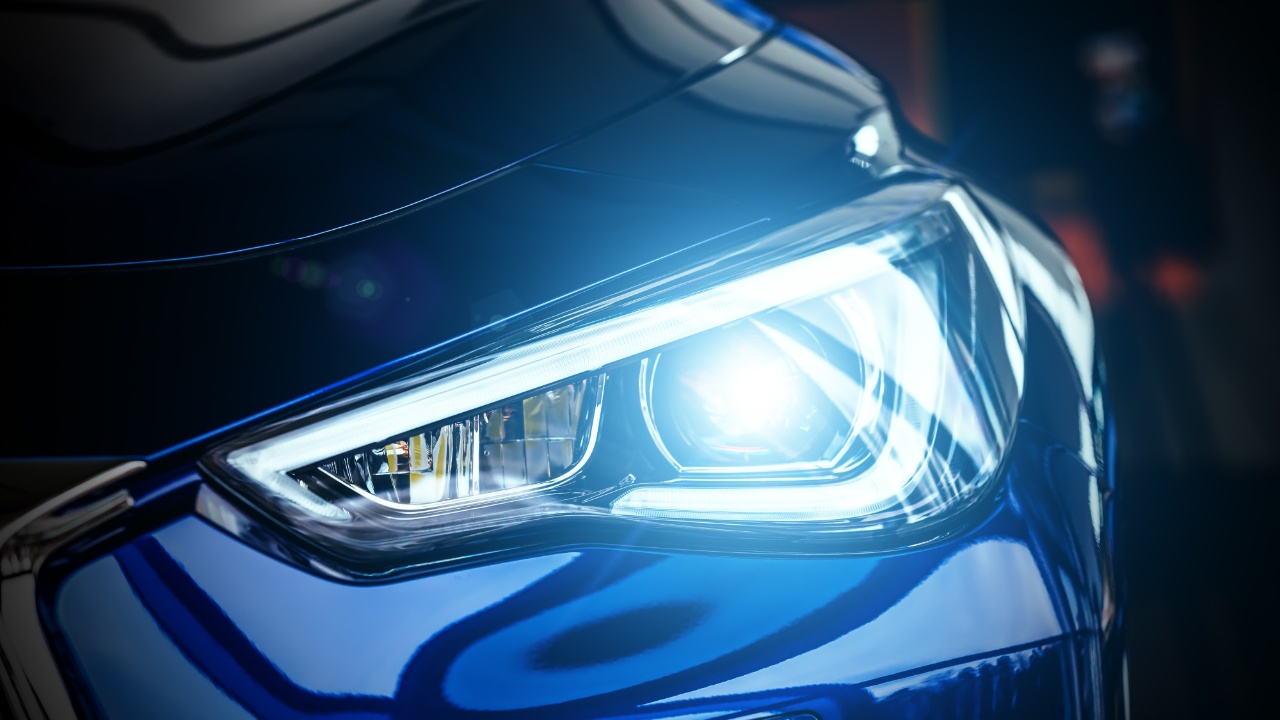 A close-up view of automotive headlights, highlighting the differences between LED and halogen lighting technology
