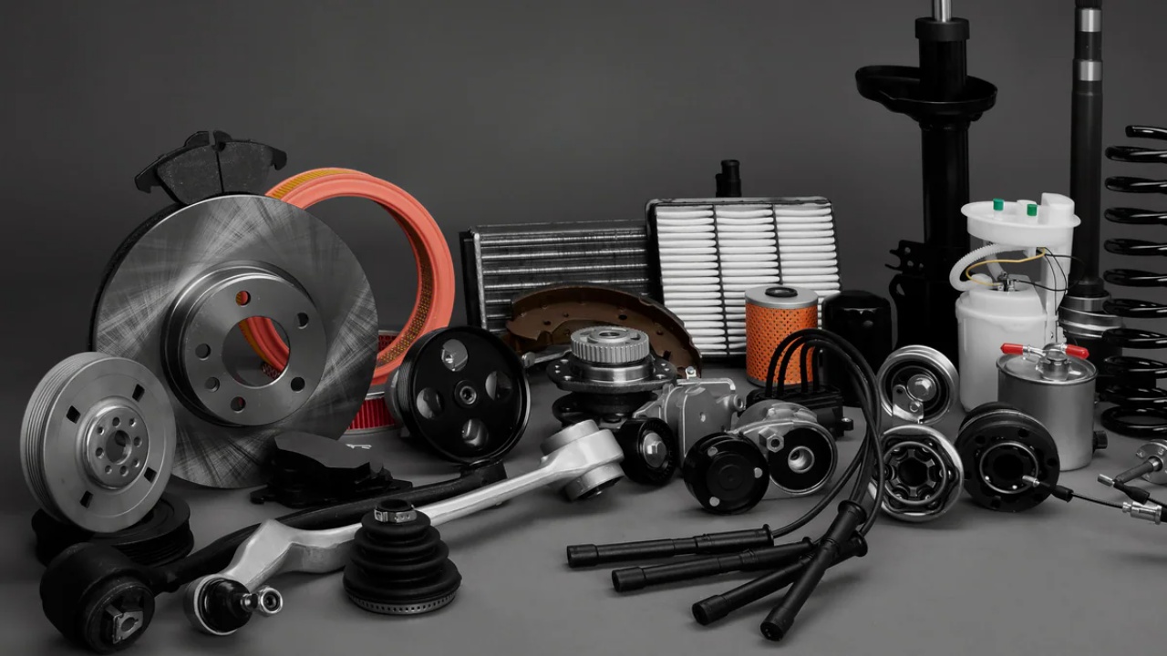 A collection of automotive components and replacement parts arranged for inspection or repair