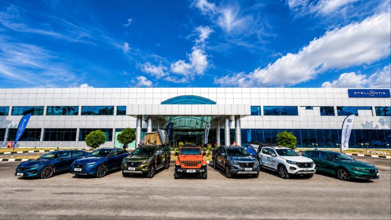 A Stellantis facility showcases a diverse lineup of vehicles outside its modern headquarters