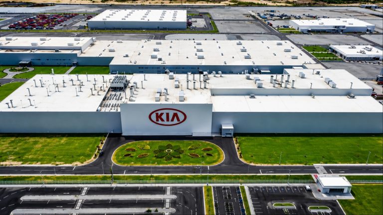 Aerial view of a sprawling Kia manufacturing facility with expansive buildings and landscaped grounds