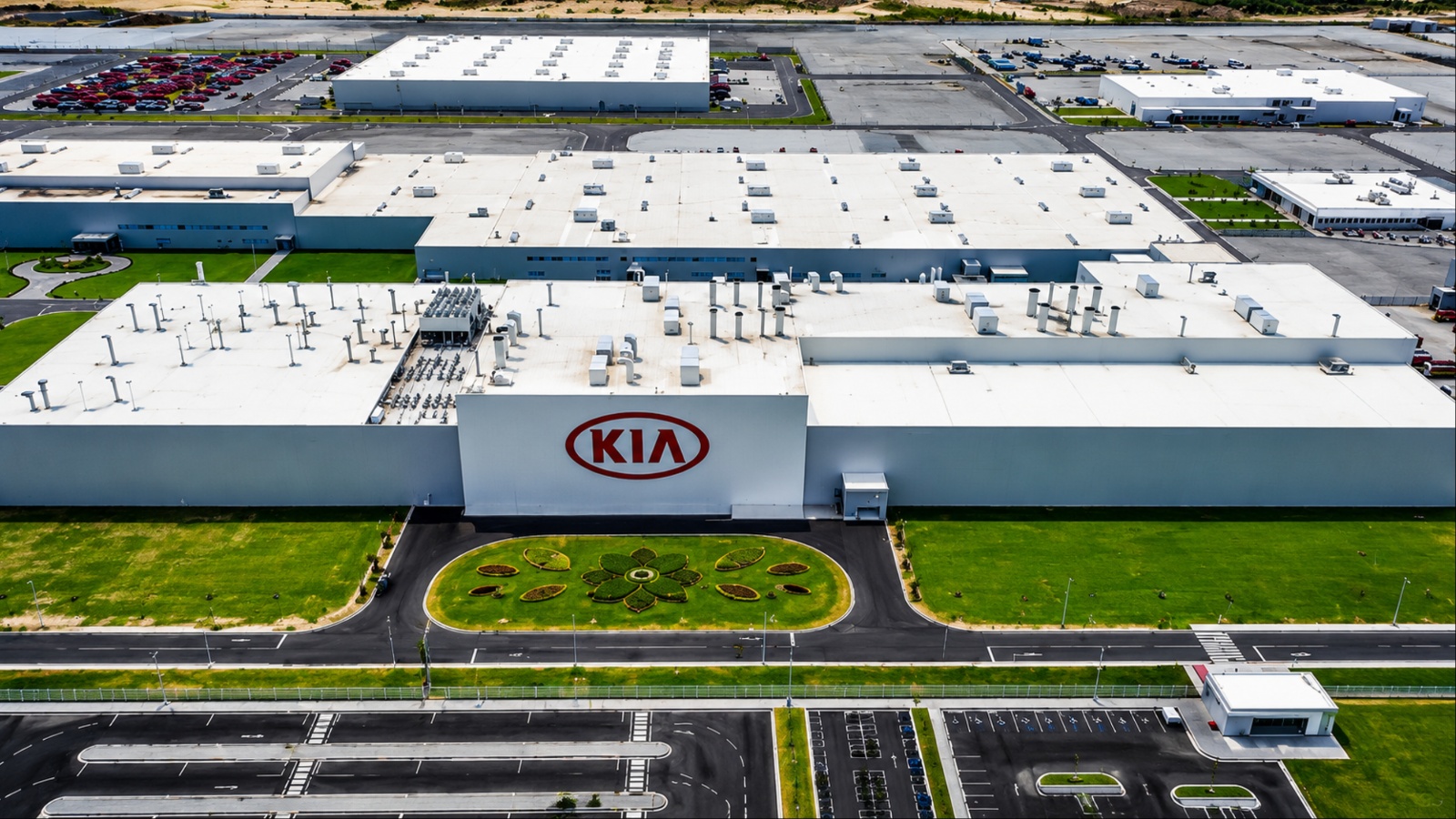 Aerial view of a sprawling Kia manufacturing facility with expansive buildings and landscaped grounds