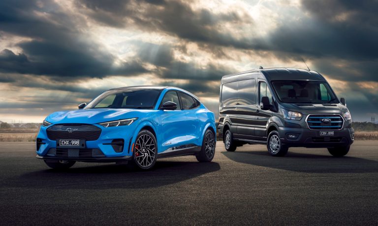 Blue ford mustang mach-e electric suv parked alongside a dark grey ford e-transit electric cargo van