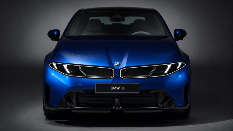 BMW i3 displayed from the front in a dark studio setting, highlighting its modern design