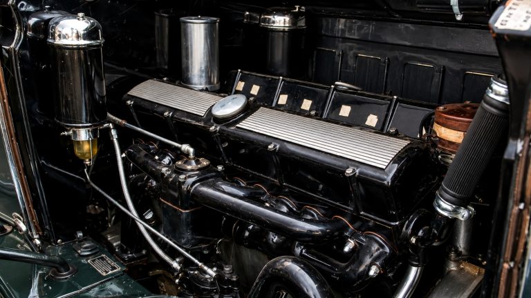 detailed close-up view of a classic black and chrome Cadillac V16 engine bay