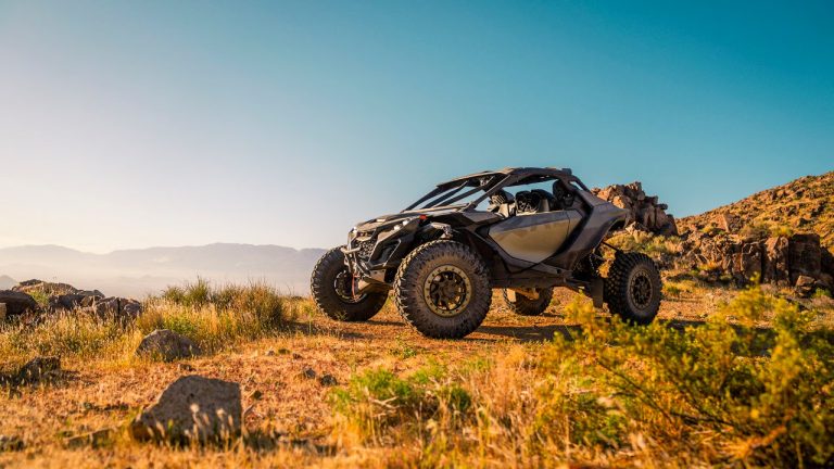 Can-Am Maverick R tackling rugged desert terrain, showcasing its high-performance suspension and extreme off-road capability