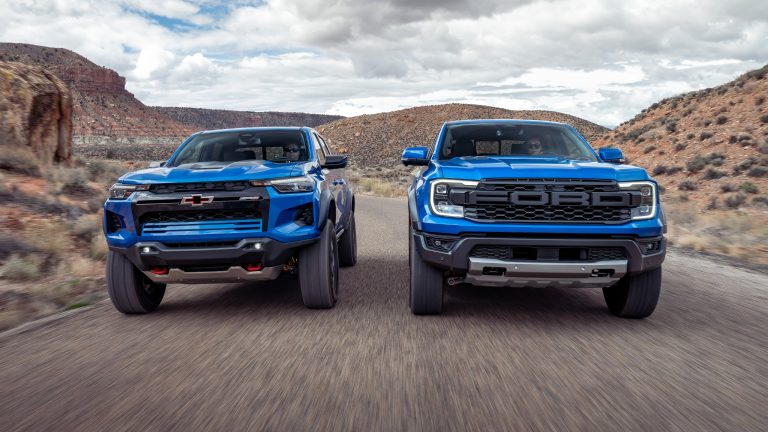 Chevrolet Colorado ZR2 and Ford Ranger Raptor drive side-by-side through rugged desert terrain