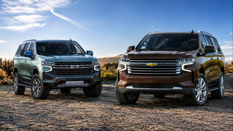 Two Chevrolet Tahoe SUVs parked outdoors, green and brown colors