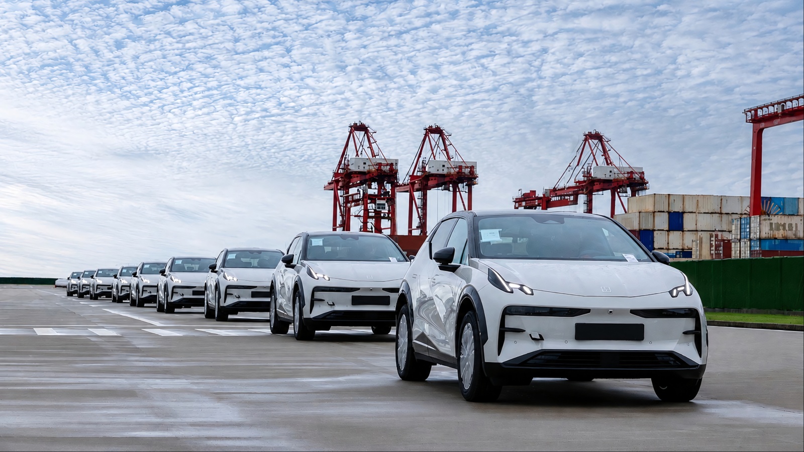 Chinese electric cars lined up at a port, highlighting rapid EV manufacturing and exports
