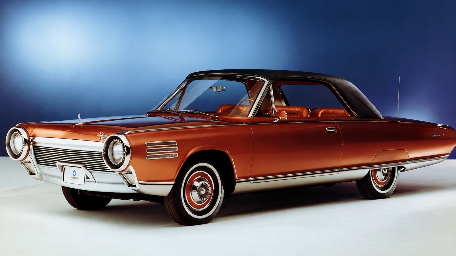 vintage bronze Chrysler Turbine car parked against a sleek gradient blue studio background