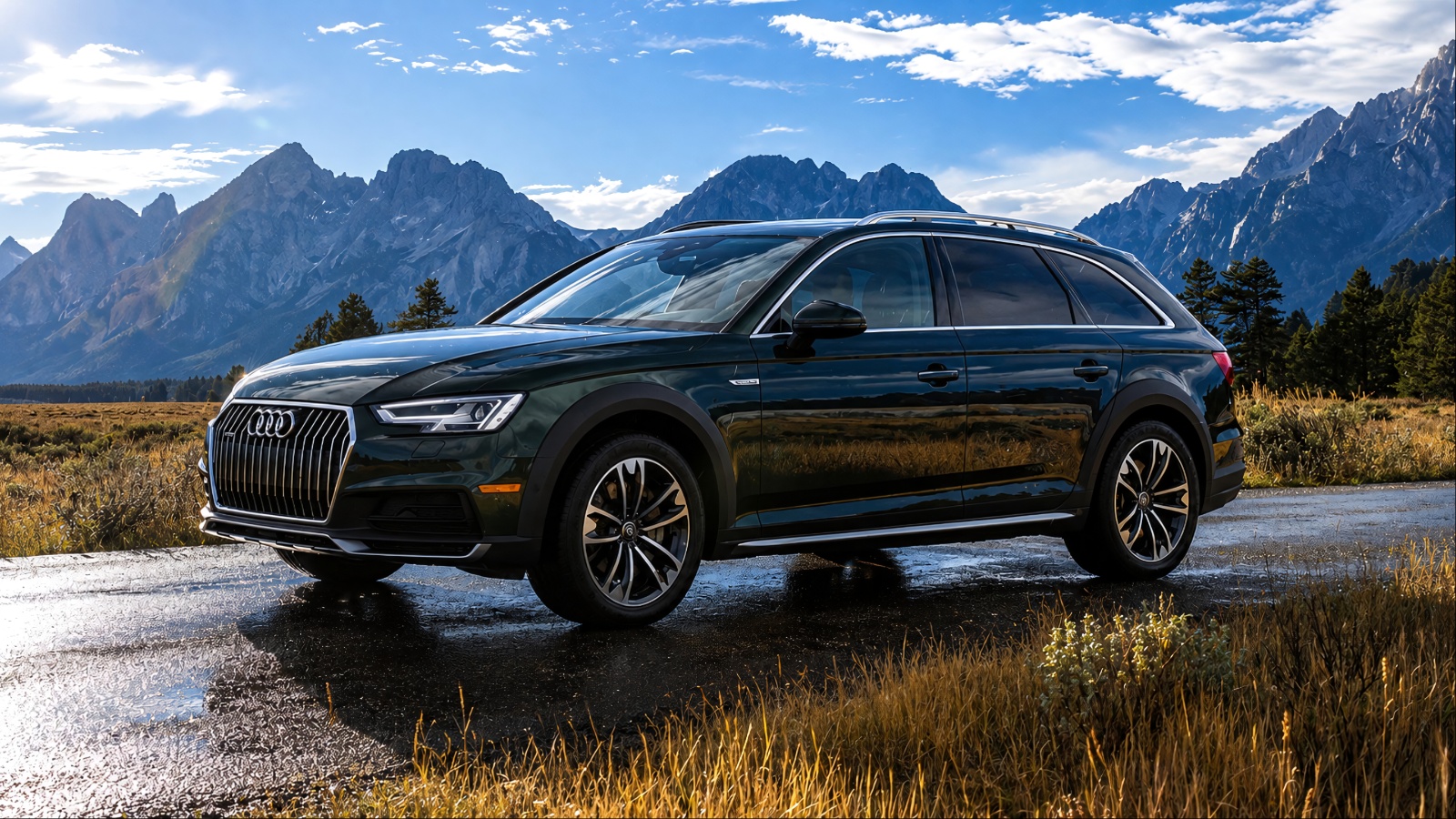 Dark green Audi A4 Allroad parked against a dramatic mountain backdrop