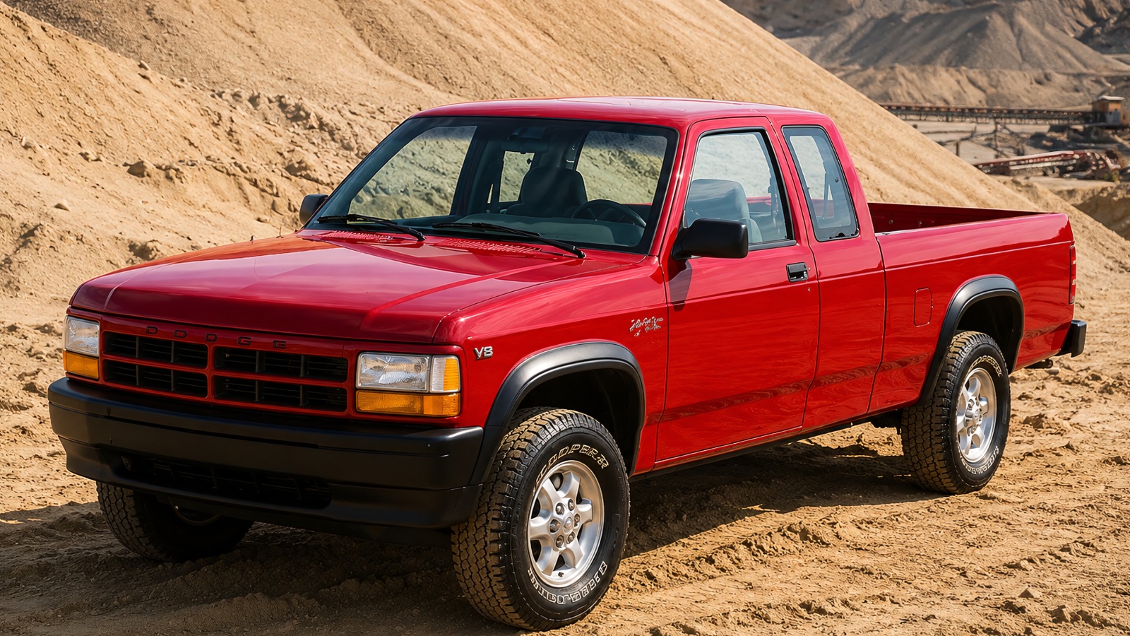 A red Dodge Dakota is standing on a hilly desert