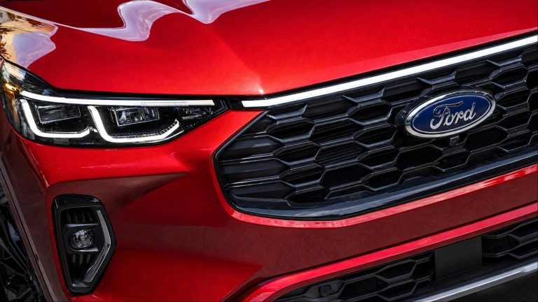 Close-up of the front grille and headlight of a red Ford car