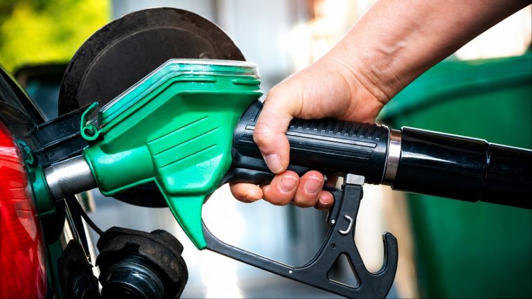 Fuel pump nozzle inserted into a vehicle at a gas station