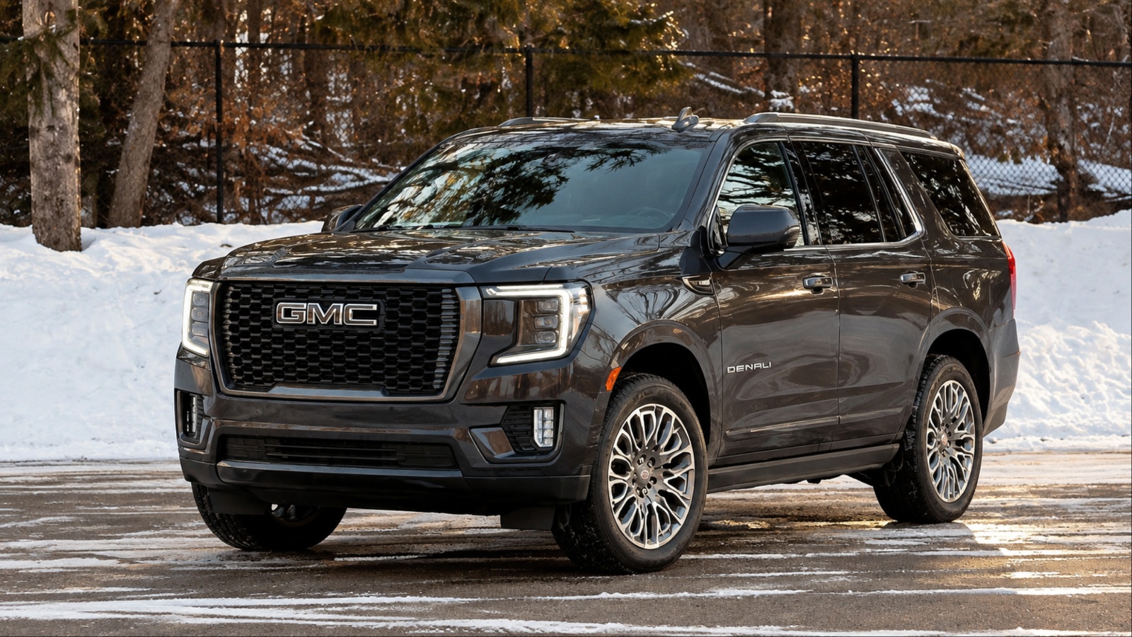 GMC Yukon Denali parked on a snowy road surrounded by winter scenery