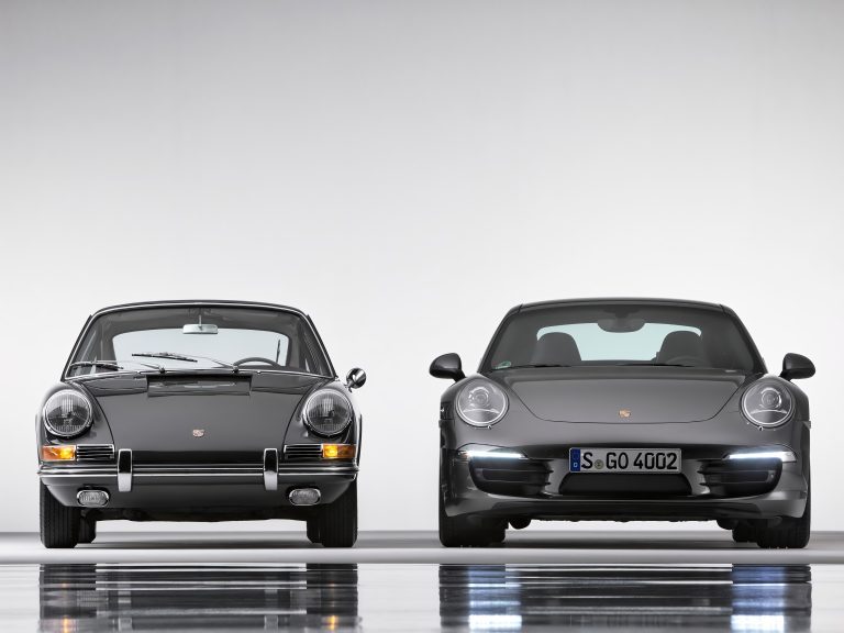 Modern gray Porsche 911 (991 generation) is displayed here alongside its classic ancestor
