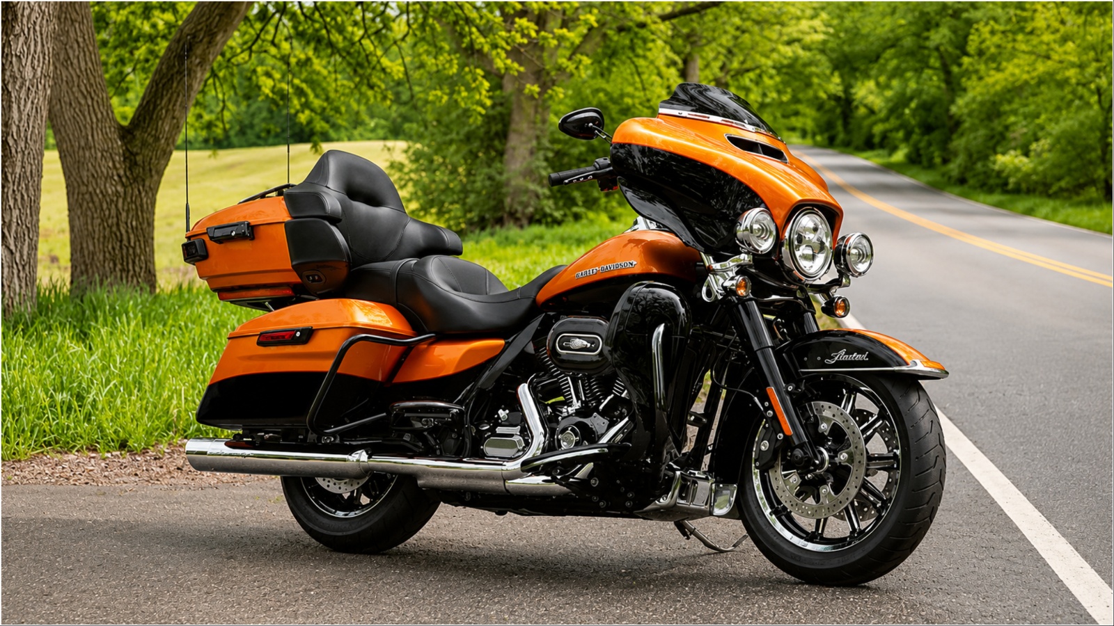 Harley-Davidson touring motorcycle parked beside a scenic road surrounded by lush greenery