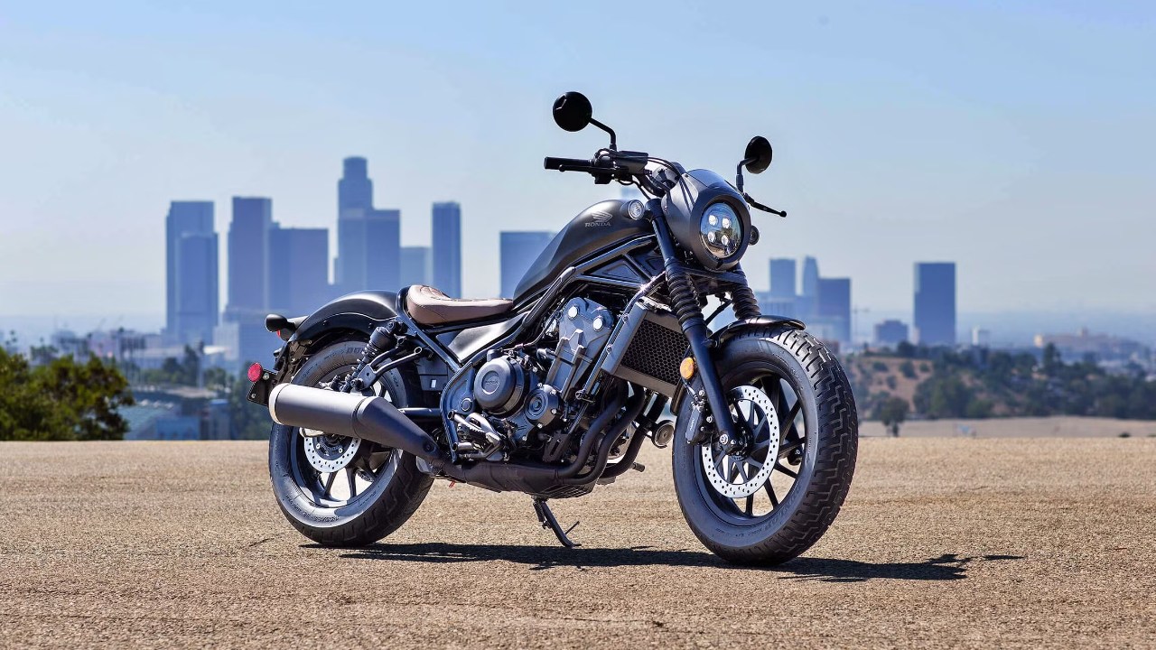 Honda Rebel 500 motorcycle overlooking the Los Angeles skyline under a clear blue sky
