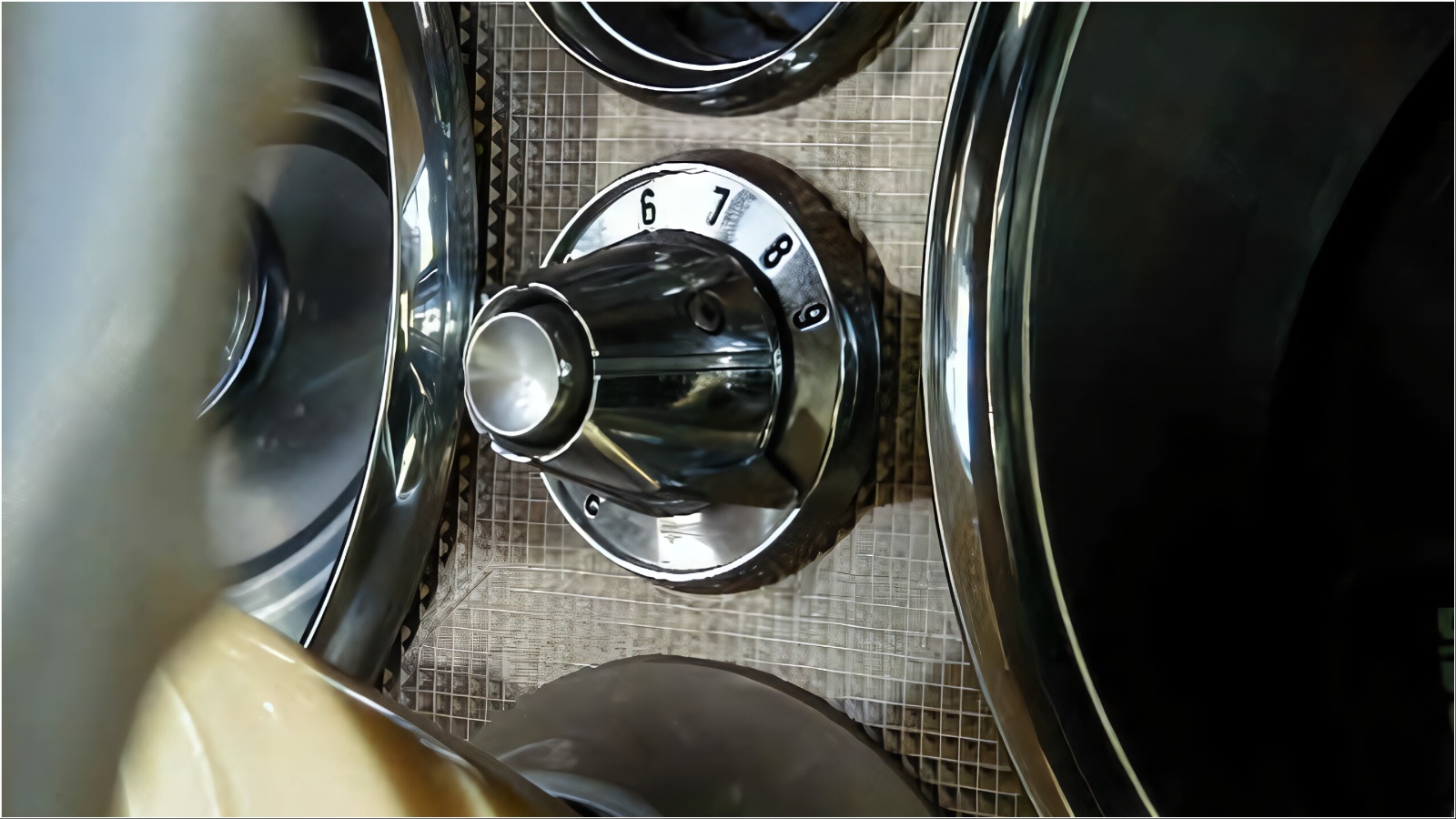 Close-up of a vintage chrome dial dashboard control knob