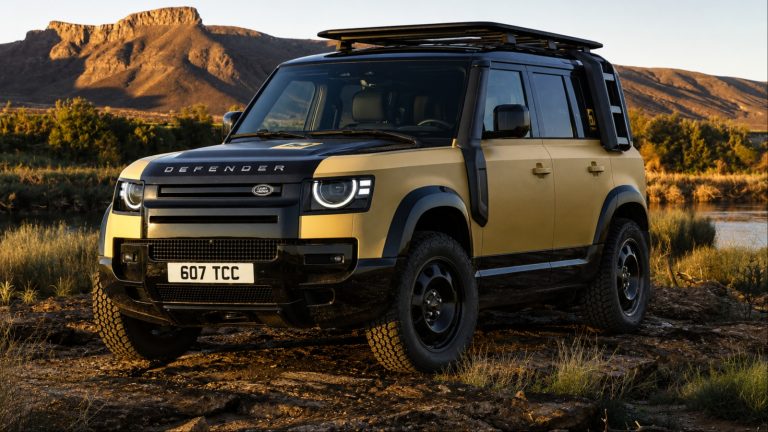brown Land Rover is standing on a deserted hill