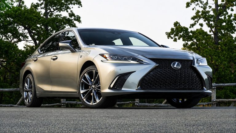 Lexus ES 350 parked on a scenic road, showcasing its elegant design and bold front grille