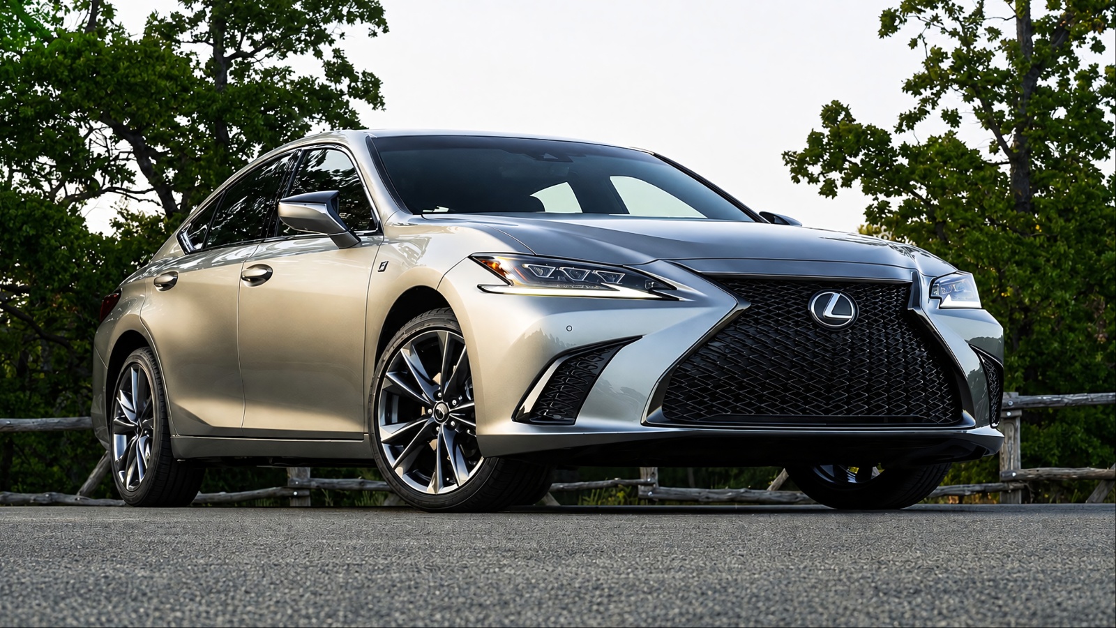 Lexus ES 350 parked on a scenic road, showcasing its elegant design and bold front grille
