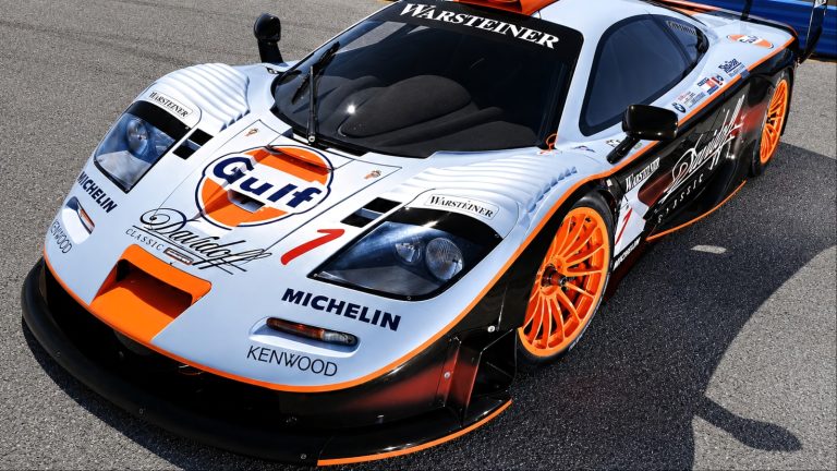 McLaren F1 GTR race car in Gulf livery, featuring a large rear wing and aerodynamic bodywork