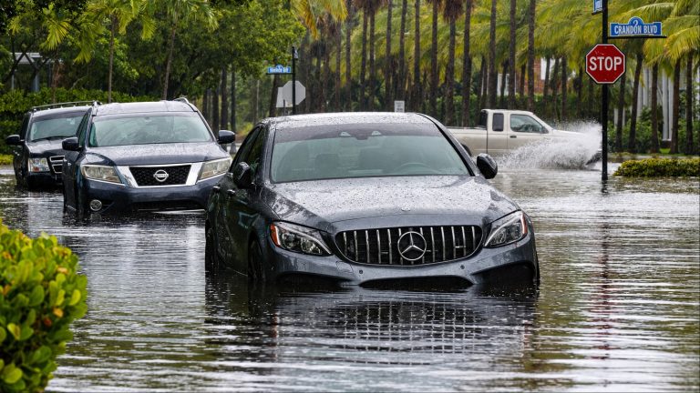 Mercedes-Benz C-Class AMG driving through a flooded street