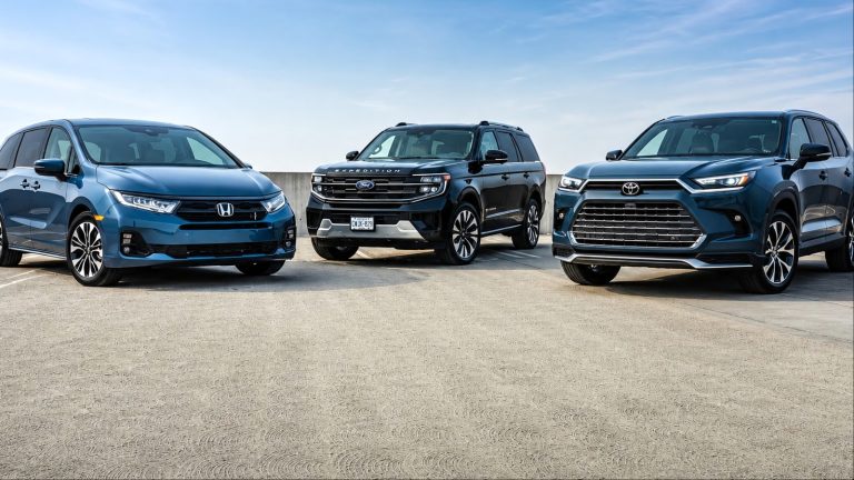 Blue Honda Odyssey, black Ford Expedition, and blue Toyota Highlander parked