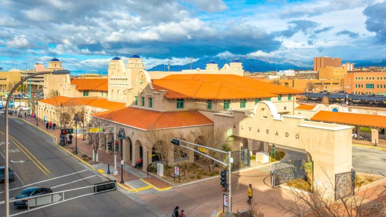 new mexico urban landmark surrounded by mountains and vibrant skies