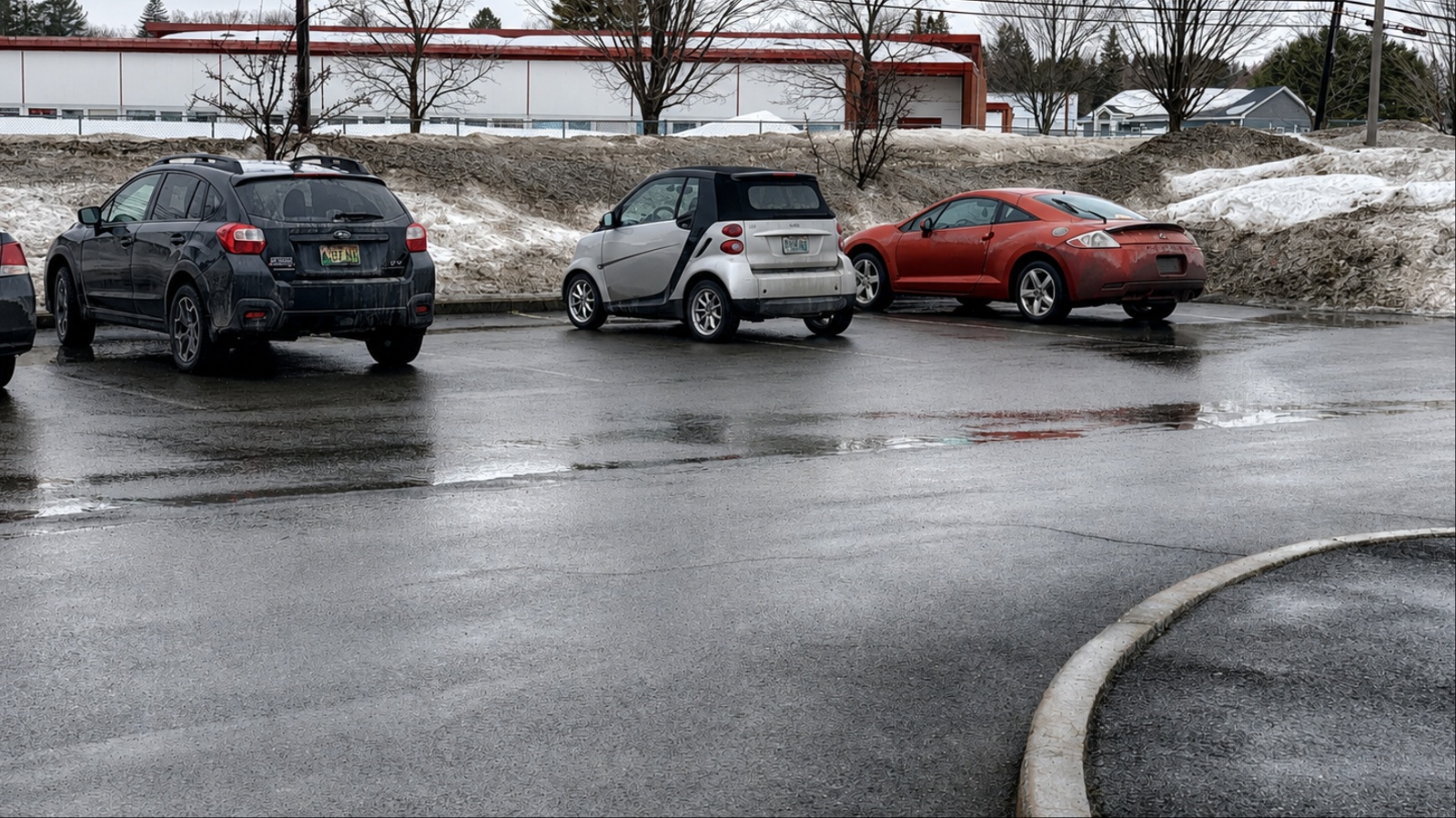 Parking lot with three parked cars