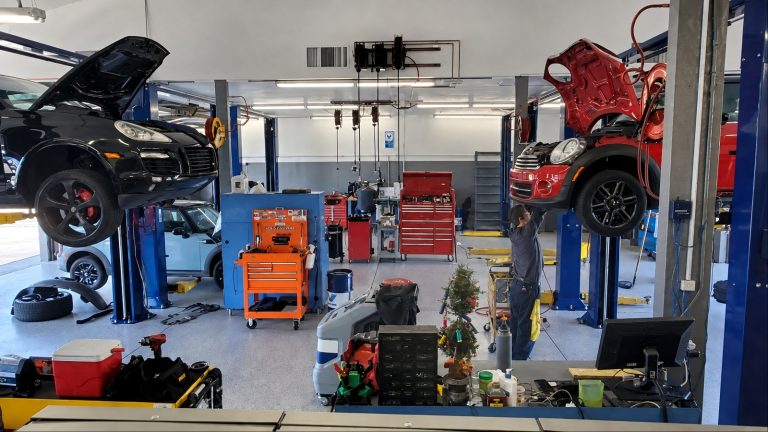 Professional auto repair shop servicing vehicles with expert tools and technicians