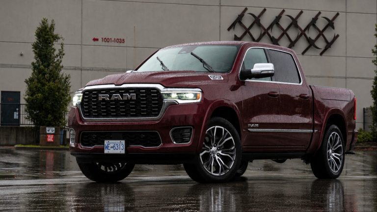 Ram 1500 is standing behind a factory
