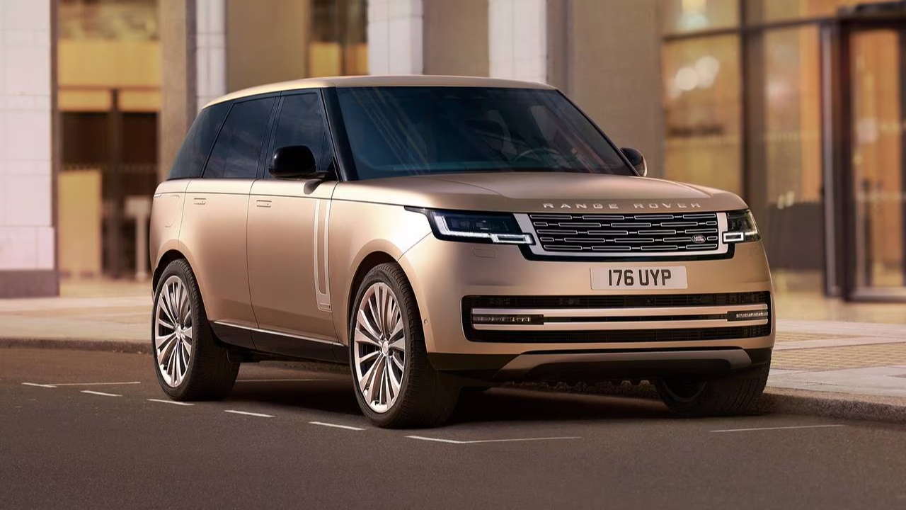 Range Rover parked along a city street beside modern buildings