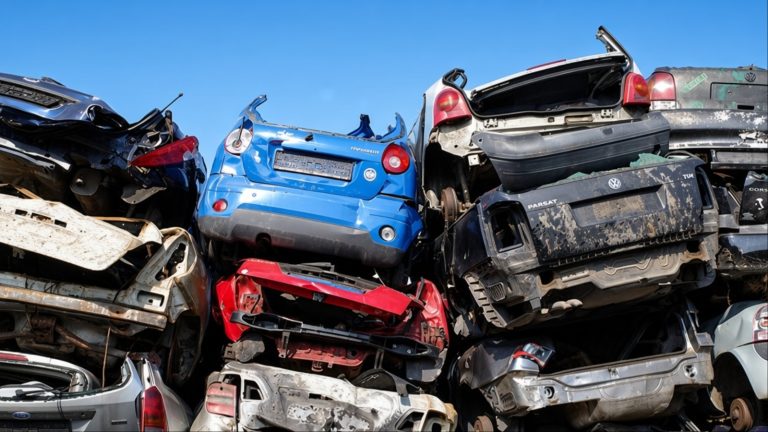 Stacked cars on the grounds of a car scrap yard