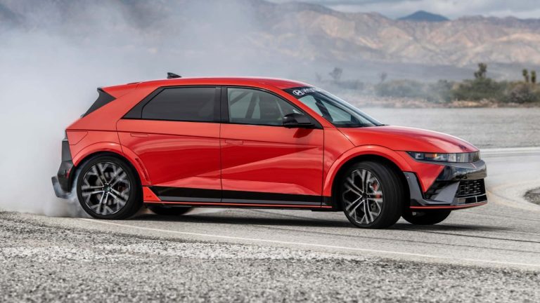 Red Hyundai Ioniq 5 N drifting on a mountain road, tires smoking