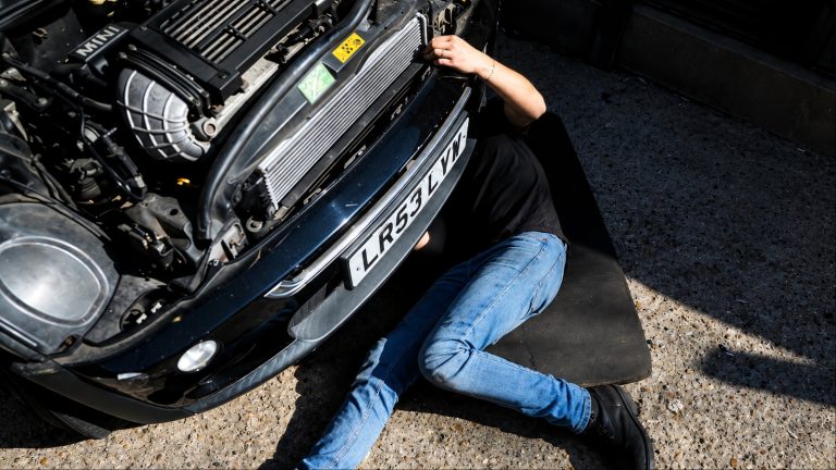 Repairing Mini's engine under the scorching summer sun
