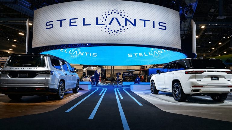Stellantis automakers display featuring Jeep SUVs at an illuminated auto show