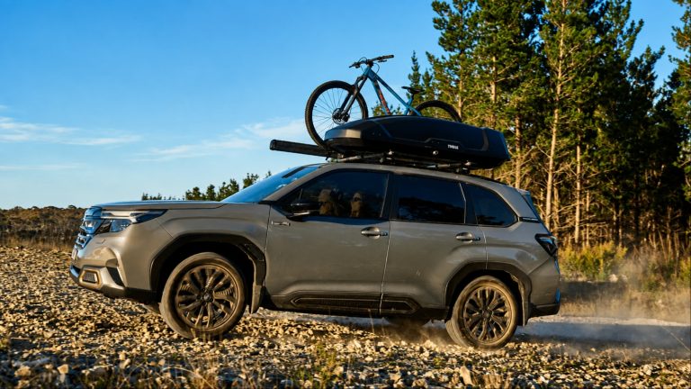 Subaru Forester is carrying a bicycle on a rough road