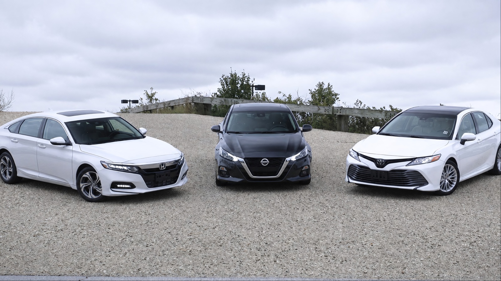 Toyota Camry, Honda Accord, and Nissan Altima lined up for a midsize sedan comparison