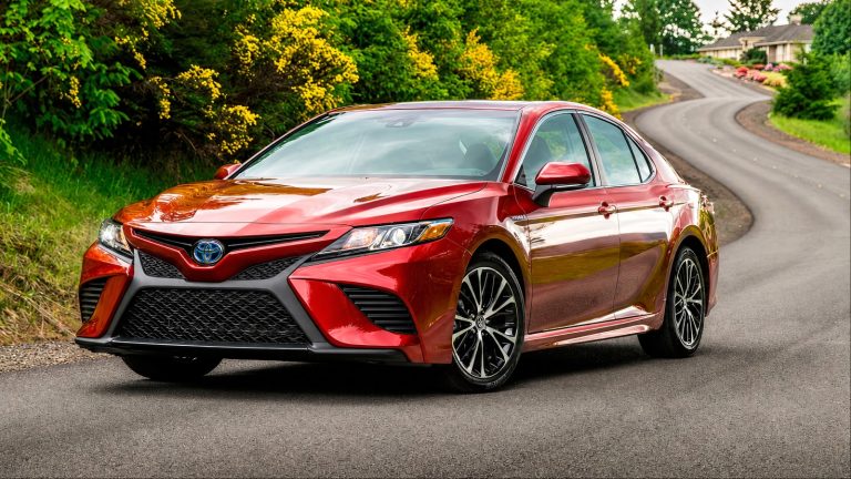 Toyota Camry Hybrid parked on a scenic road, showcasing its efficient and refined sedan design