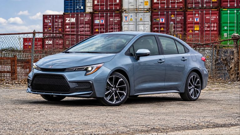 A Toyota Corolla is standing in front of cargo boxes
