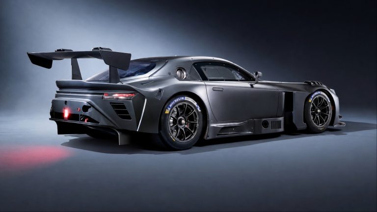 Toyota GR GT race car with aggressive aerodynamics, massive wing, sleek body, and dramatic studio lighting